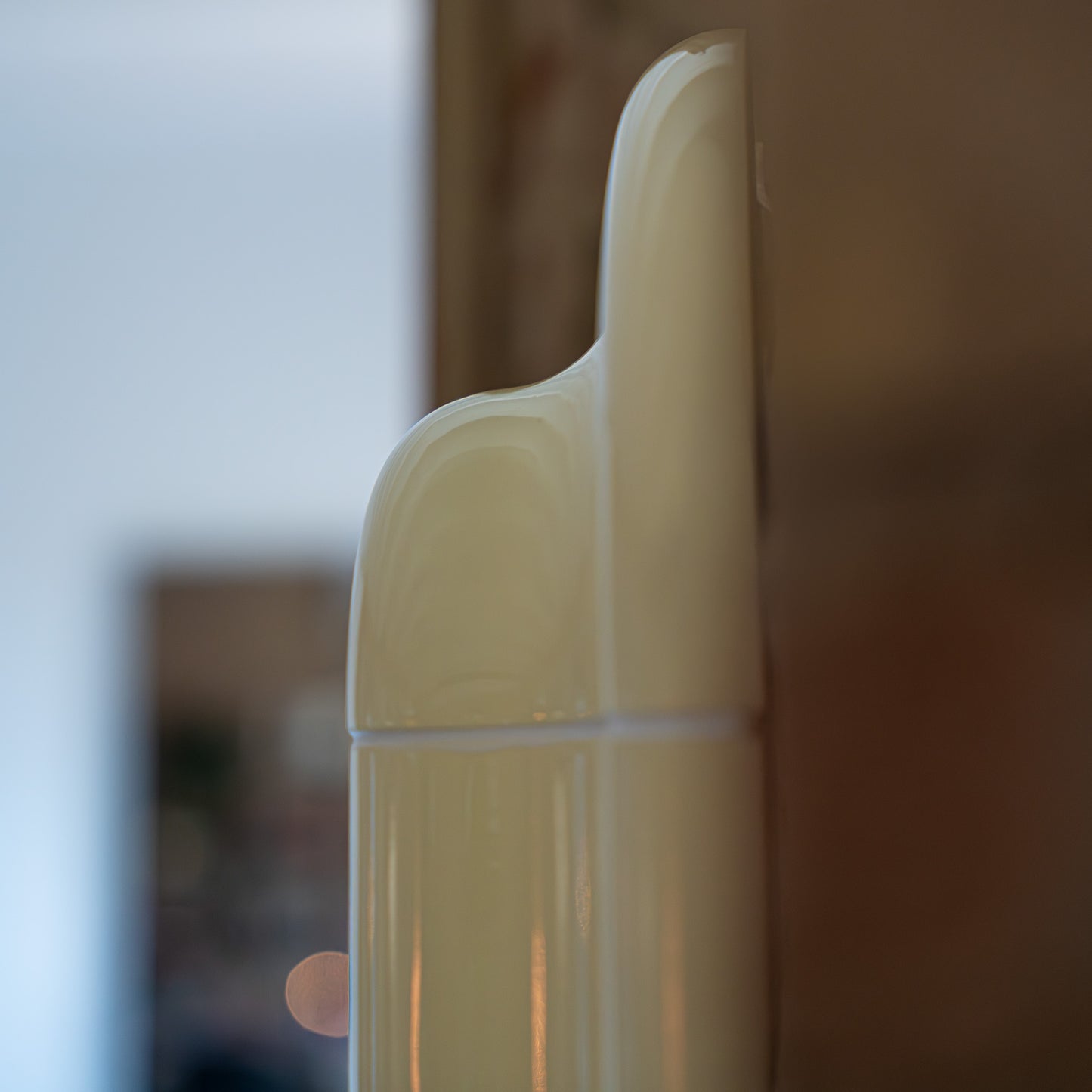 Close-up detail of the Soft Butter ceramic-look surface, showing subtle joints, gloss, and handcrafted texture.
