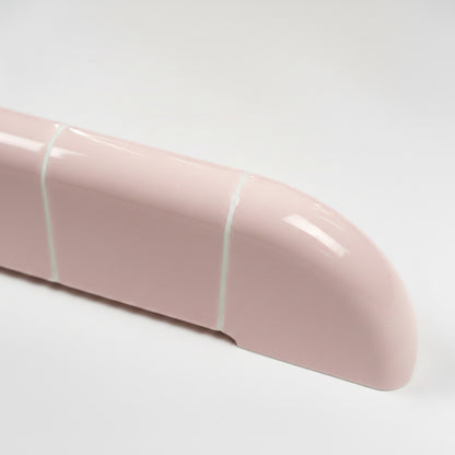 Close-up of the Orbi shelf in glossy Blush Pink, highlighting its smooth rounded edges and ceramic-inspired craftsmanship.