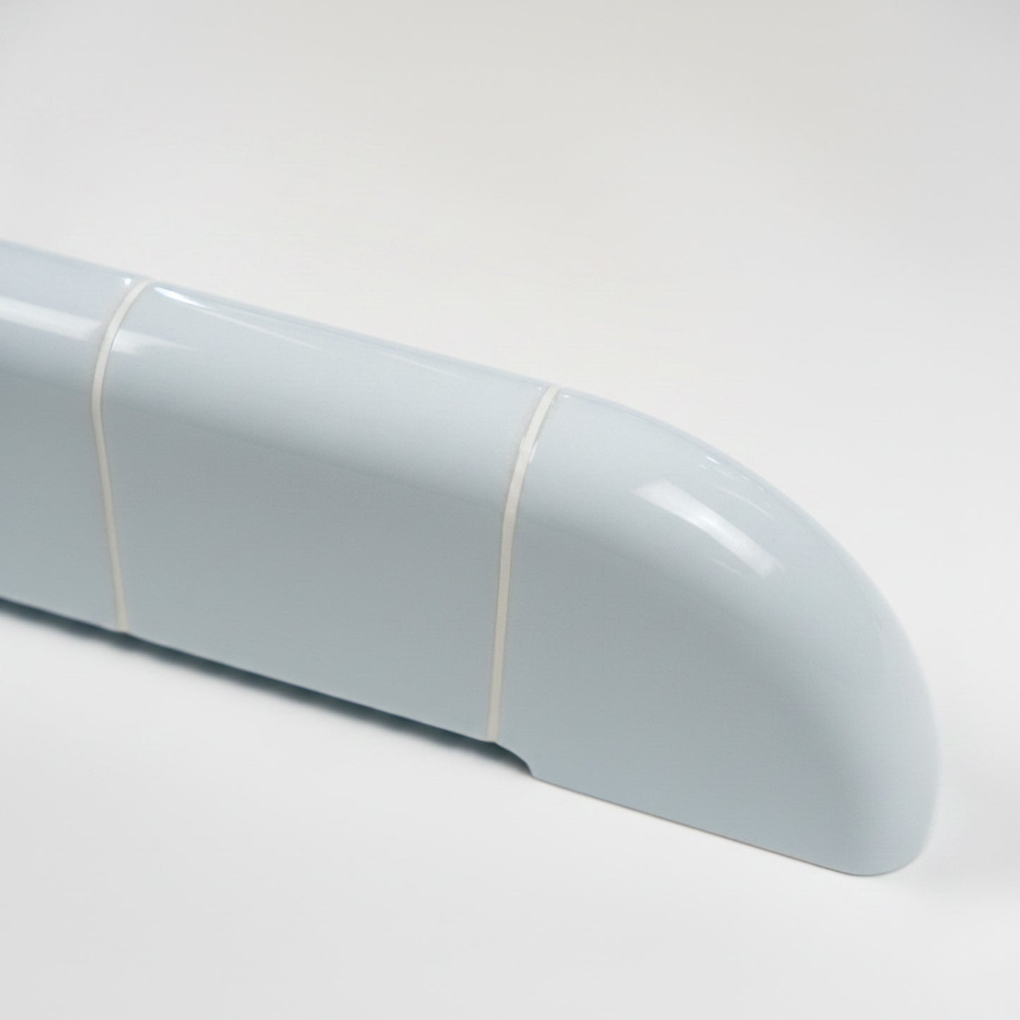 Close-up of the Orbi shelf in glossy Ice Blue, highlighting its rounded ceramic-inspired surface.