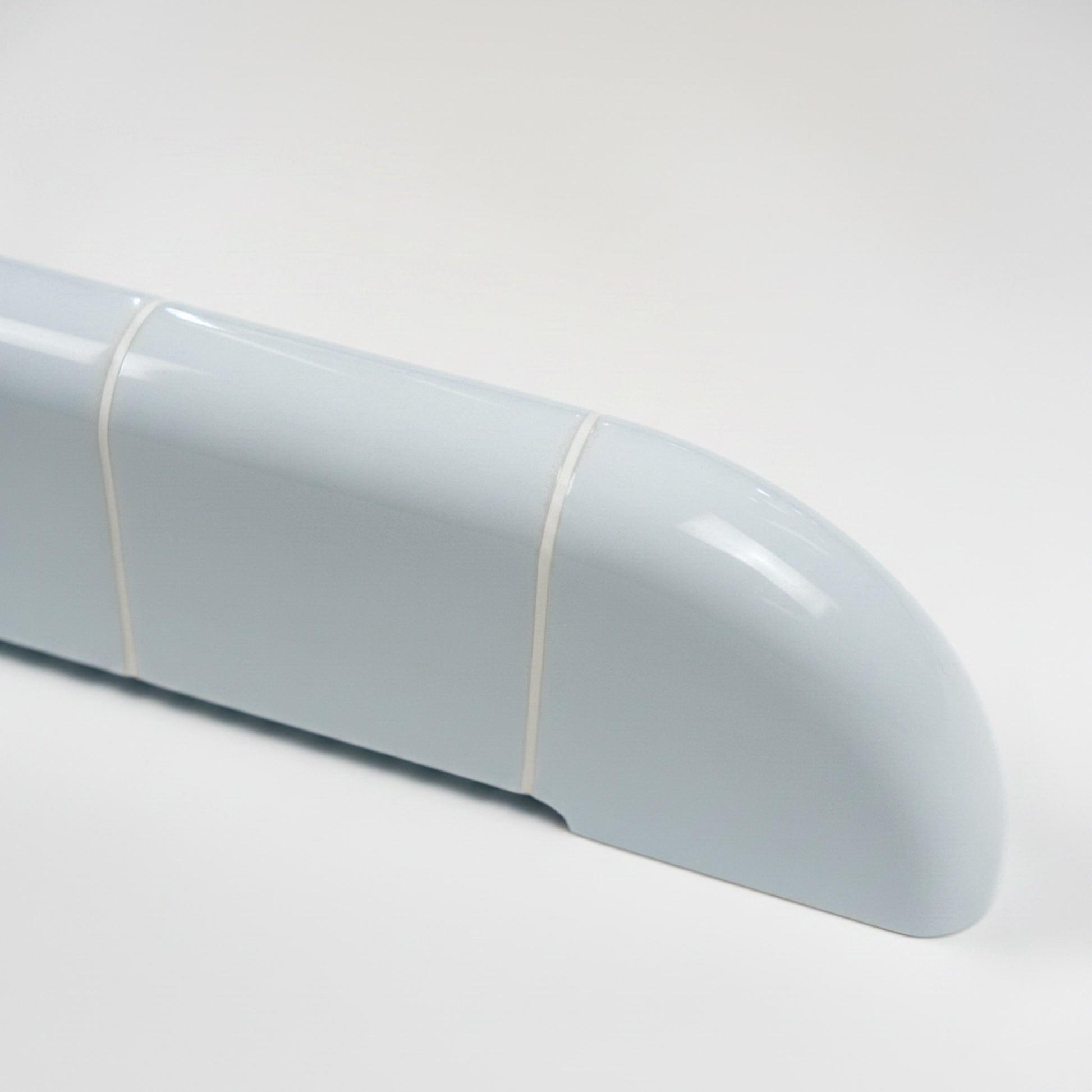 Close-up of the Orbi shelf in glossy Ice Blue, highlighting its rounded ceramic-inspired surface.