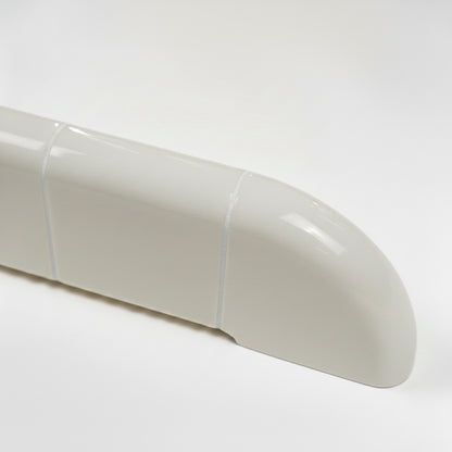 Close-up of the Orbi wall shelf showing the glossy Off-White finish and rounded ceramic-inspired details.
