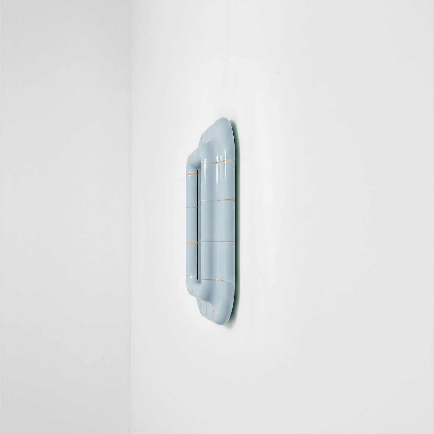 Side view of the Ice Blue ceramic-look mirror showing frame depth and curved profile.