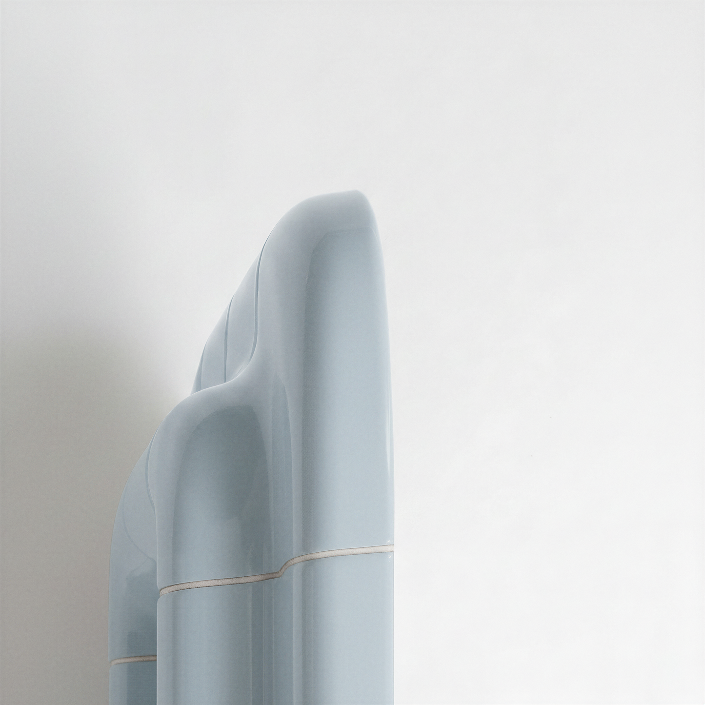 Side view of the Ice Blue ceramic-look mirror showing frame depth and curved profile.