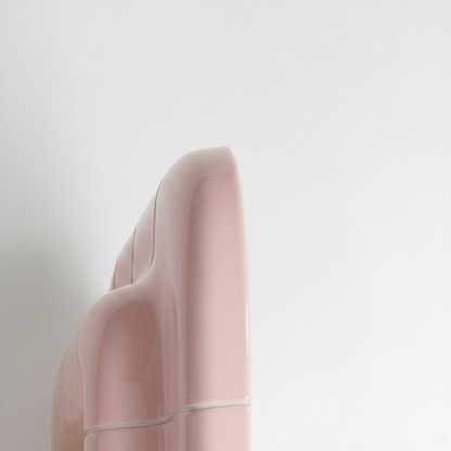 Rear angle view highlighting the sculptural volume of the blush pink mirror frame.