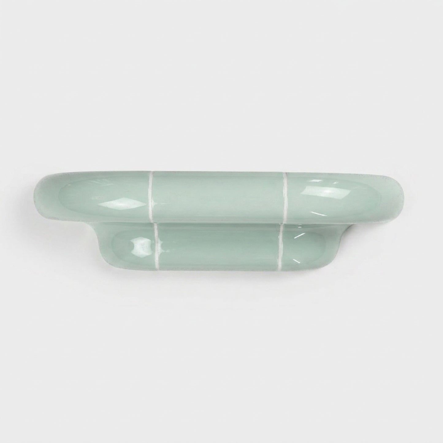 Orbi S modular wall shelf in glossy Pastel Mint with a sculptural ceramic-inspired design.