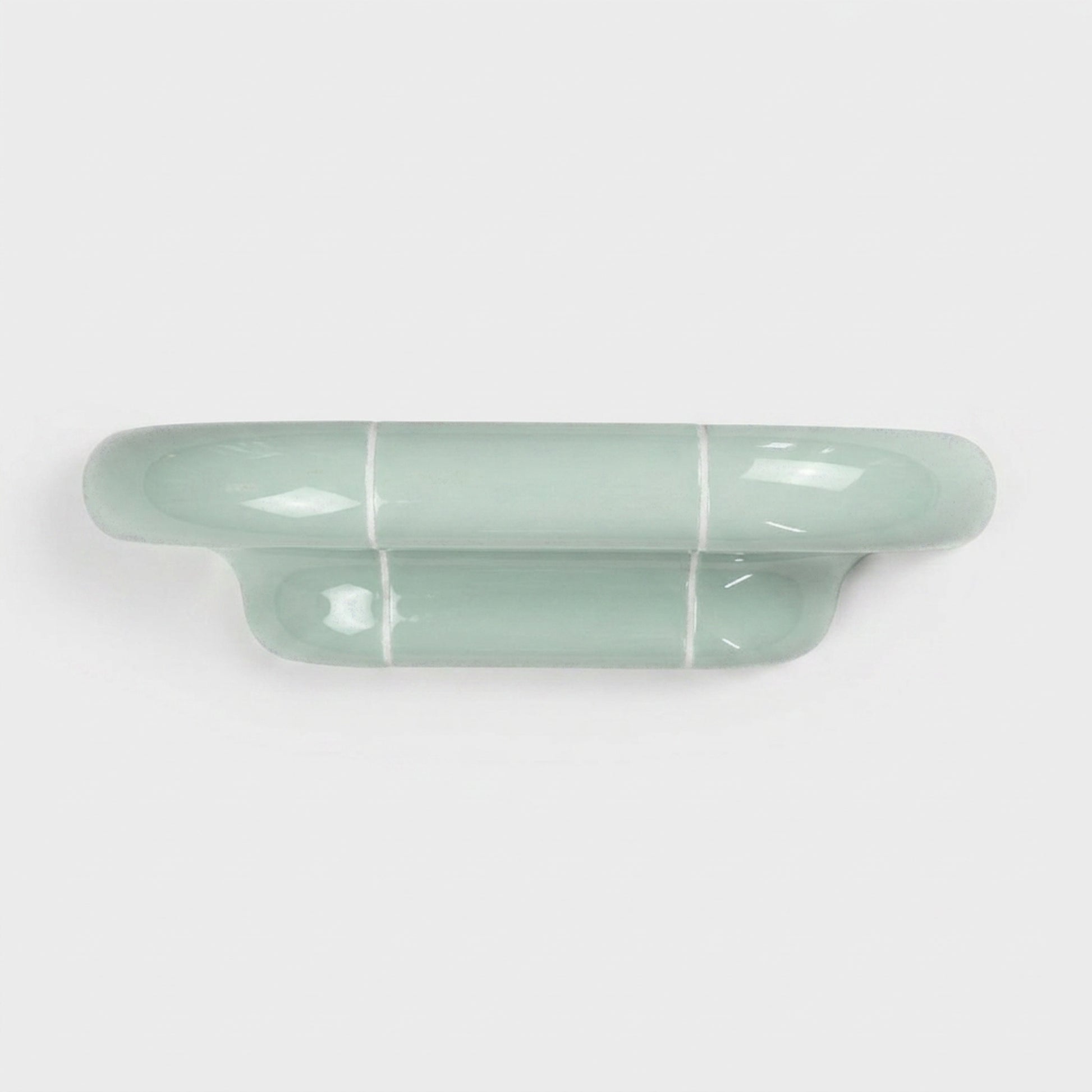Orbi S modular wall shelf in glossy Pastel Mint with a sculptural ceramic-inspired design.
