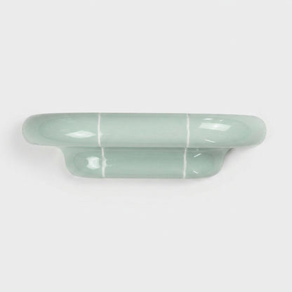 Orbi S modular wall shelf in glossy Pastel Mint with a sculptural ceramic-inspired design.