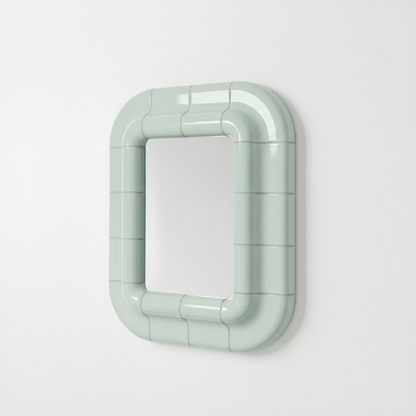 Soft Mint ceramic-look mirror shown in angled perspective, highlighting its sculptural frame.