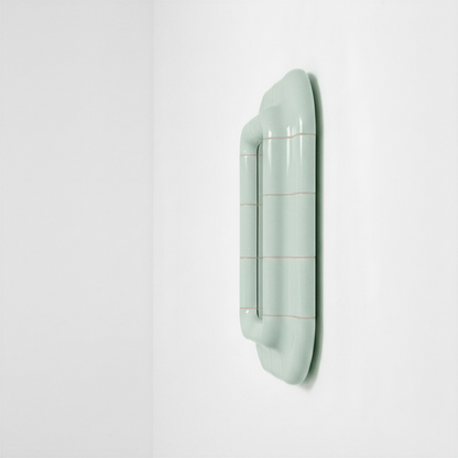 Side view of the Soft Mint ceramic-look mirror showing frame depth and curved profile.