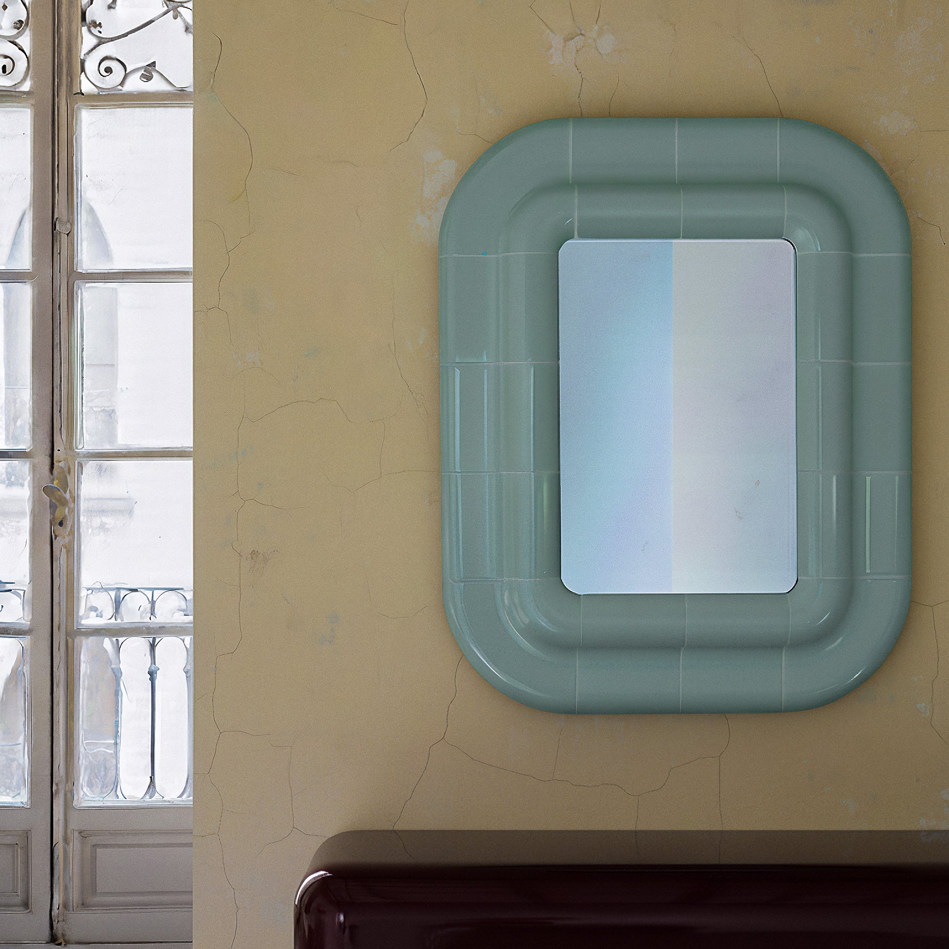 Soft Mint ceramic-look mirror mounted vertically in a residential interior.