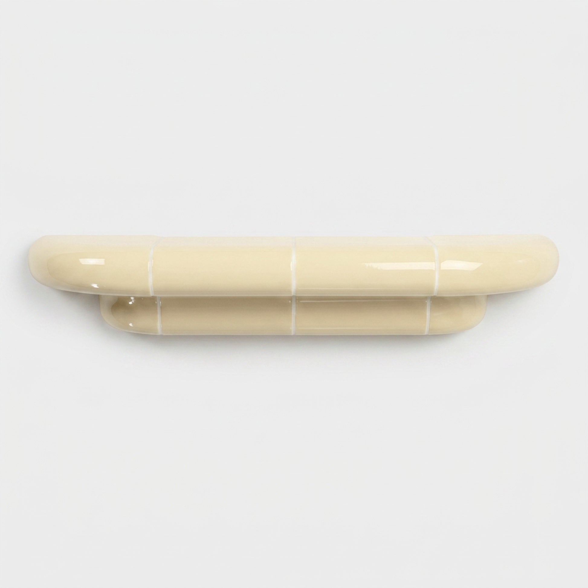 Orbi M floating shelf in glossy Soft Butter, handcrafted designer shelf with rounded forms.