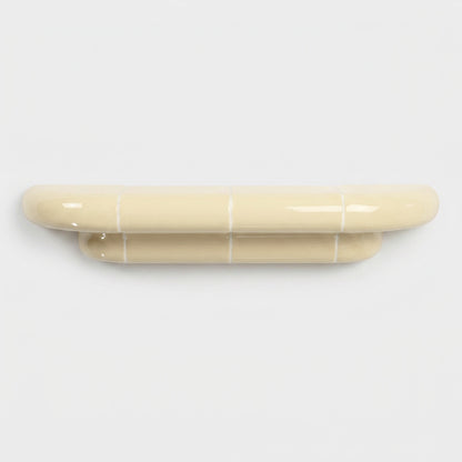 Orbi M floating shelf in glossy Soft Butter, handcrafted designer shelf with rounded forms.