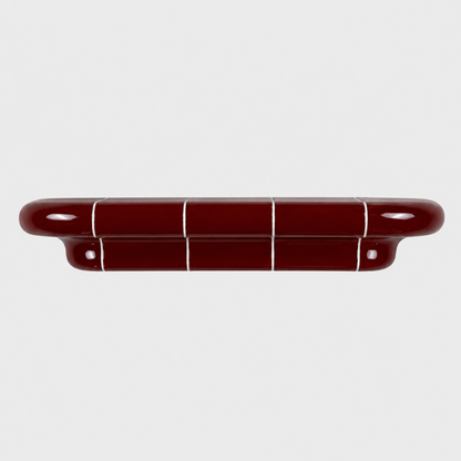 Orbi L modular shelf in glossy Deep Burgundy with ceramic-inspired rounded design.