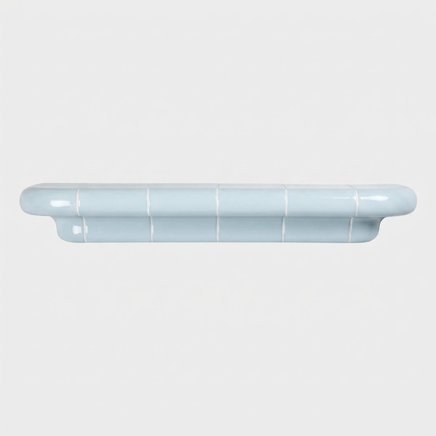 Orbi XL handcrafted shelf in glossy Ice Blue with a minimalist sculptural silhouette.