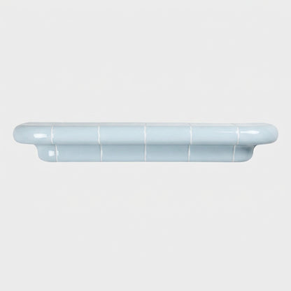 Orbi XL handcrafted shelf in glossy Ice Blue with a minimalist sculptural silhouette.