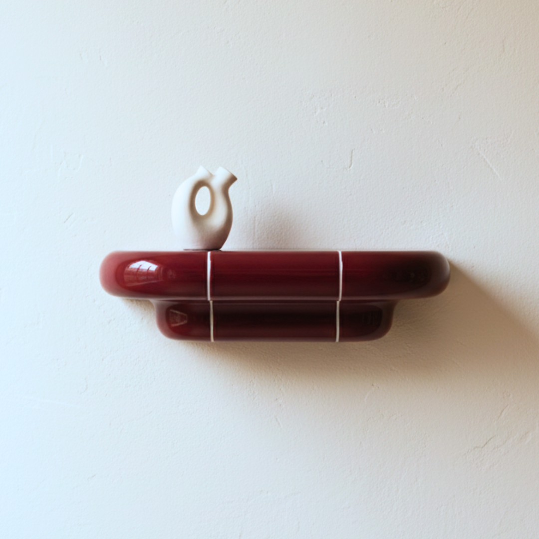 Orbi floating shelf styled with decorative ceramic vase in glossy Deep Burgundy finish.