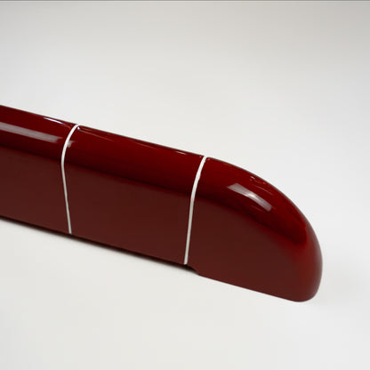 Close-up of the rounded end of the Orbi shelf in glossy Deep Burgundy, highlighting the ceramic-inspired finish.