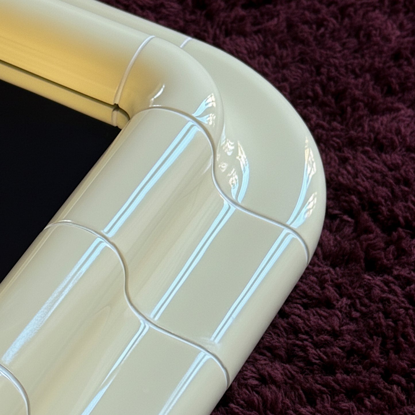 Close-up detail of the Soft Butter ceramic-look surface, showing subtle joints, gloss, and handcrafted texture.