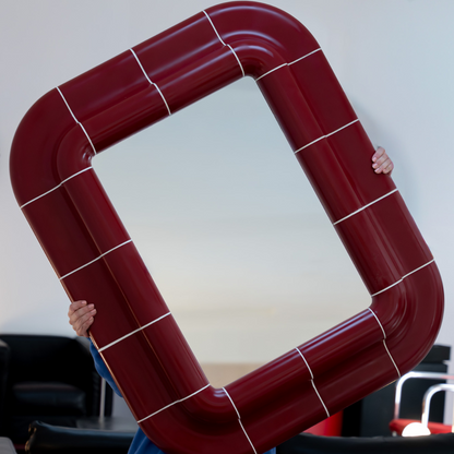 Angled view of the Lola Mirror in Deep Burgundy, showcasing its handcrafted modular frame.