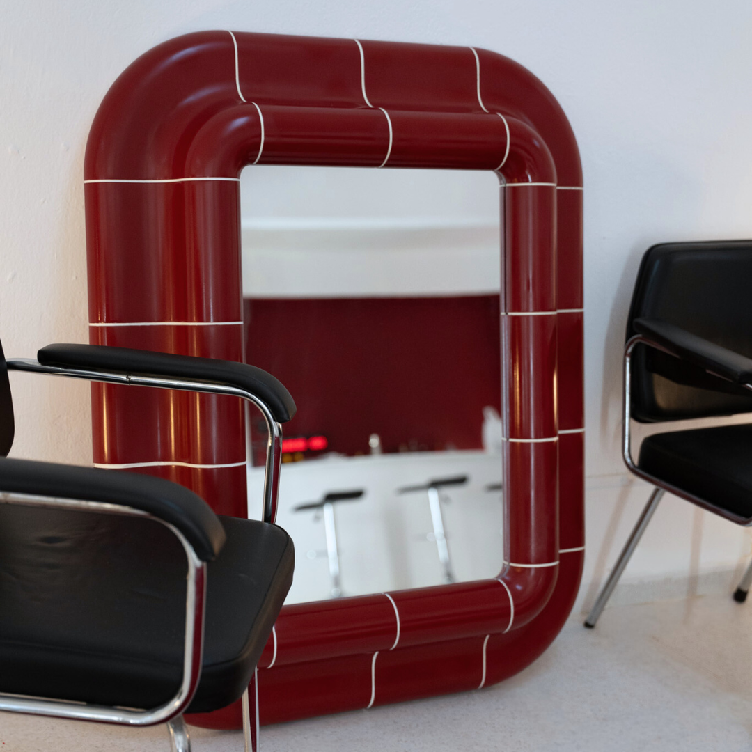 Lola Mirror in Deep Burgundy styled in a modern interior with warm natural light.