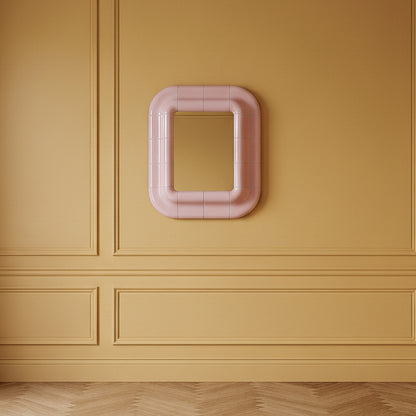 Lolita rounded wall mirror in Blush Pink high-gloss lacquer on an ochre paneled wall above a herringbone floor