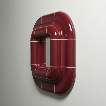 Angled side view of Lolo deep burgundy glossy ceramic mirror frame mounted on wall.