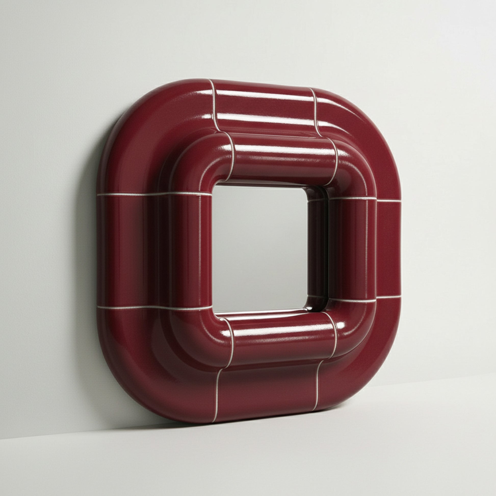 Side view of Lolo deep burgundy ceramic mirror frame showing 9 cm depth and curved structure.