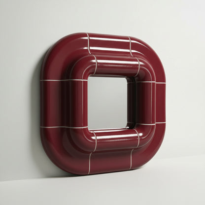 Side view of Lolo deep burgundy ceramic mirror frame showing 9 cm depth and curved structure.