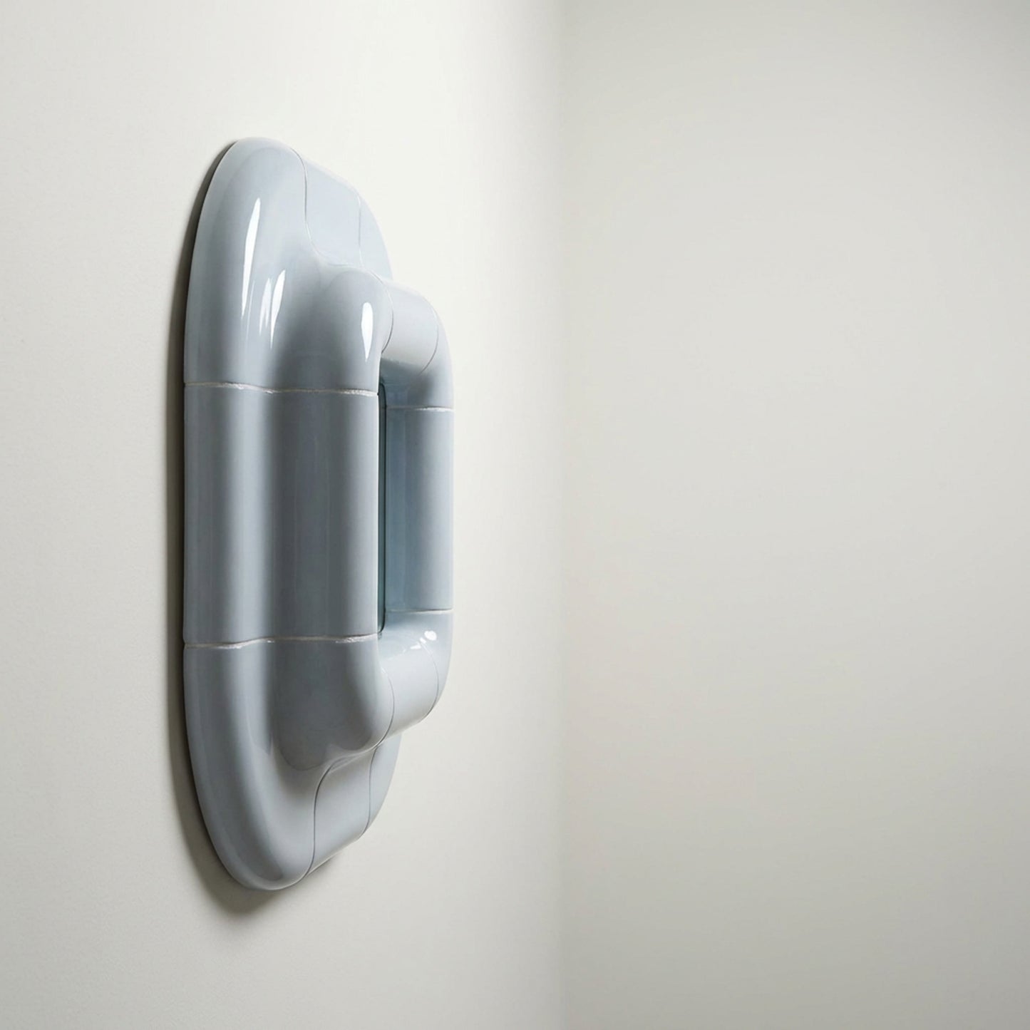 Lolo ceramic mirror in Ice Blue by Tilecito, sculptural square wall mirror with rounded tubular tile frame, 13.5 cm depth, three-quarter view