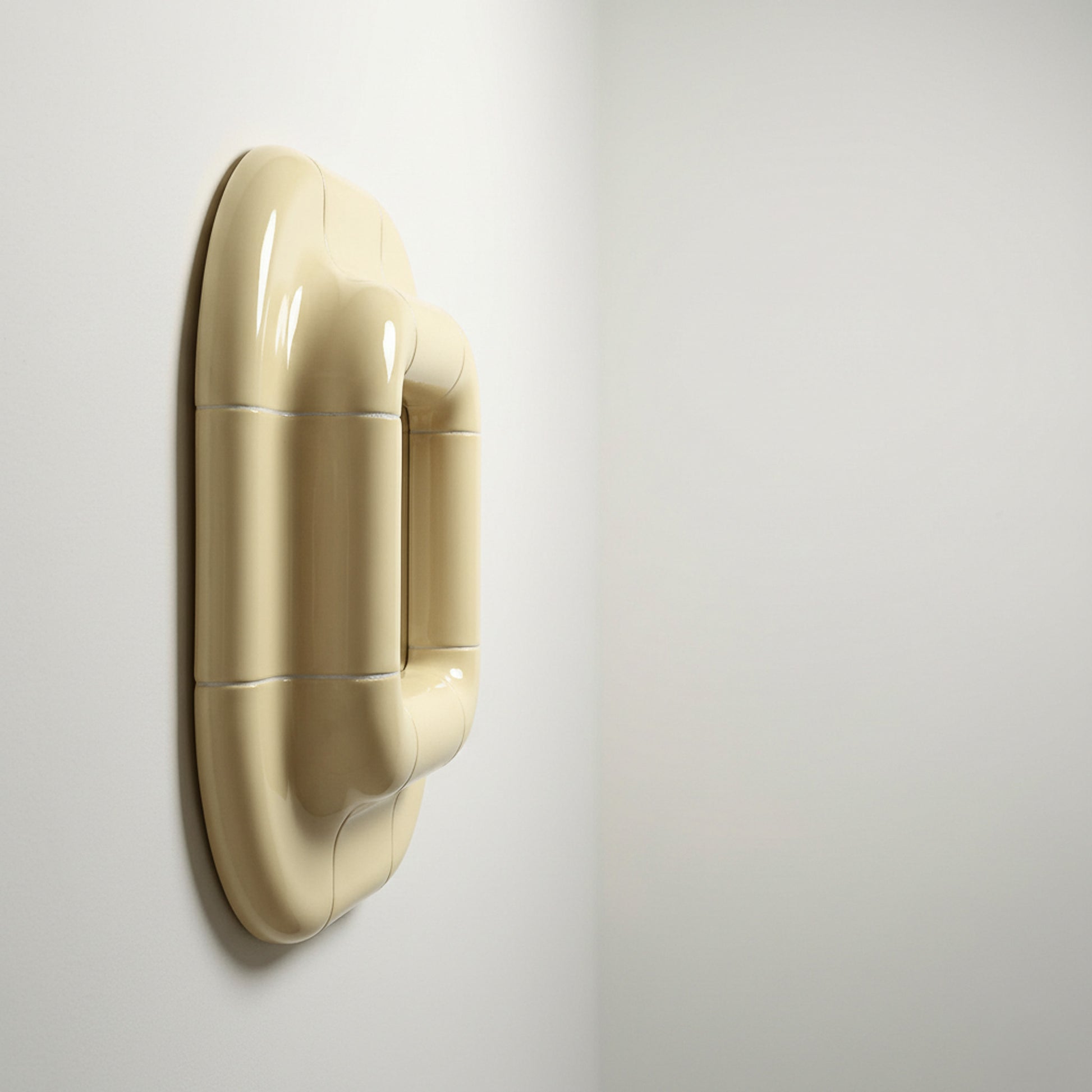 Profile view of Lolo ceramic mirror in Soft Beige by Tilecito, thick rounded tile frame mounted on wall with visible depth and glossy finish