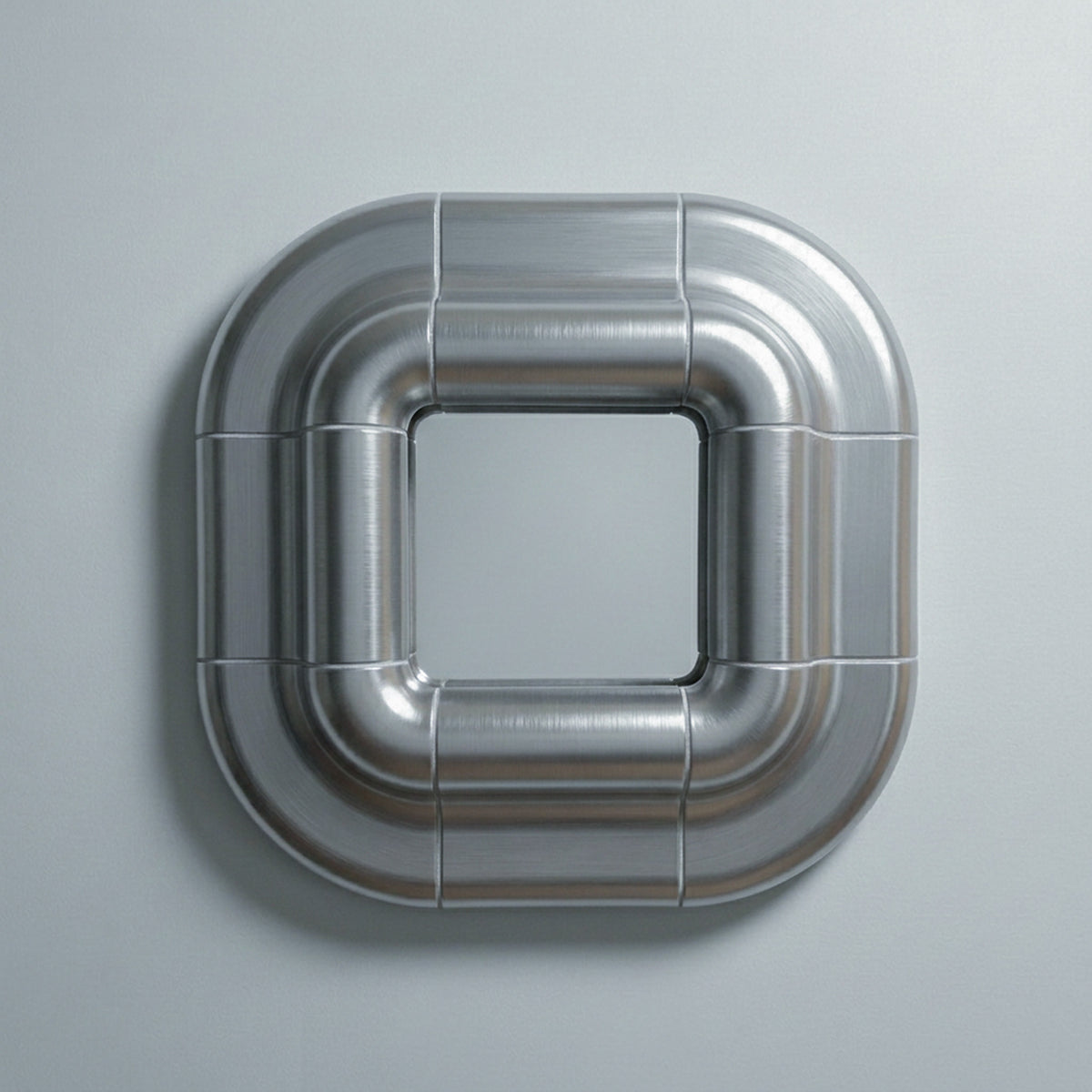 Lolo mirror in Steel finish, front view: square mirror framed by rounded, cushioned metallic rings on a light grey wall