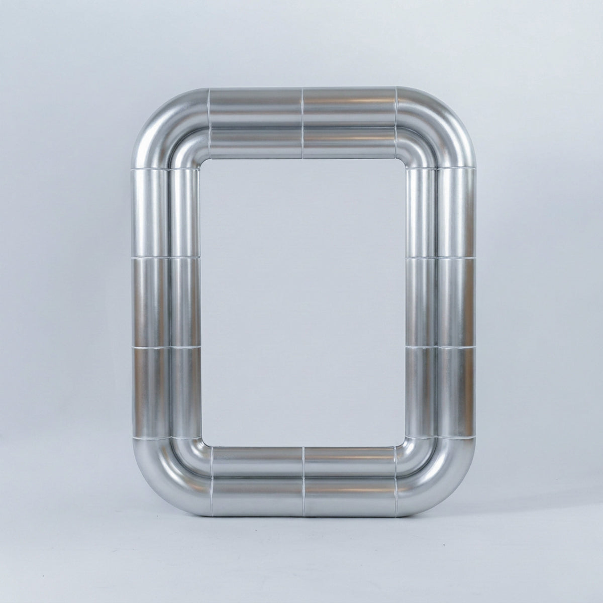 Portalito mirror in Steel finish, front view: rectangular mirror framed by a double tubular metallic structure on a light grey background